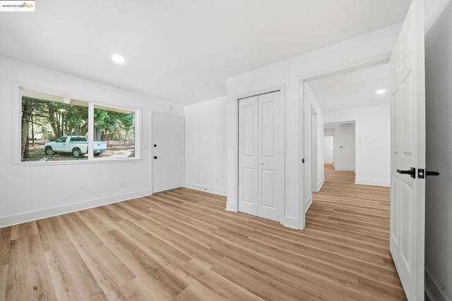 Spare room with light wood finished floors and recessed lighting
