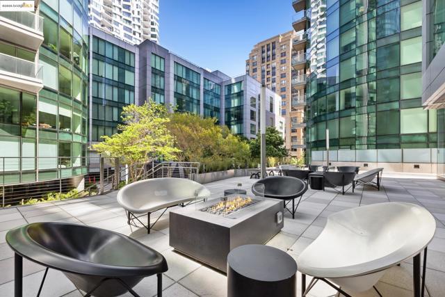 View of patio with an outdoor living space with a fire pit