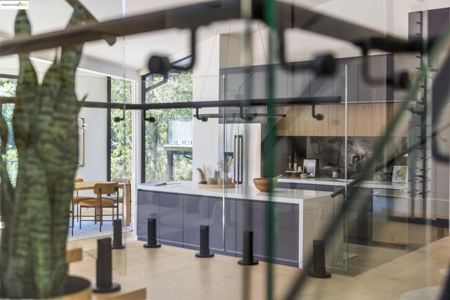 Kitchen featuring modern cabinets, light countertops, light wood-style floors, and high quality fridge