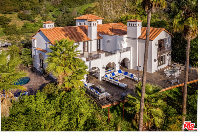 2819 Coldwater Canyon Drive Beverly Hills, California Nestled behind lush landscaping in a star studded area of Coldwater Canyon, this completely updated Spanish villa is perfect for any buyer. Enter through the dramatic 30' foyer into the formal living and dining rooms with stunning canyon views. The home seamlessly transitions from indoor to outdoor from all lower level rooms. With over 3,000 SqFt of flat outdoor space it is ideal for entertainment and the outdoor dining experience. The chef's kitchen, complete with an oversized Carrera marble island and Viking appliances, flows right into the spacious family room with an abundance of natural light. Custom beamed ceilings and beautiful walnut flooring throughout. The master suite epitomizes luxury living with a romantic fireplace, dual closets, an expansive bathroom and a private balcony. All four bedrooms are upstairs and three boast jaw-dropping views of the canyon and the grounds. Surrounded by an exquisite 25K SqFt lot, the sun-soaked pool and massive deck are idyllic for relaxation