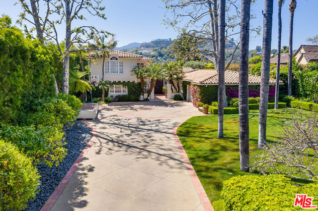 111 S ROCKINGHAM Avenue Los Angeles, California Gorgeous, Mediterranean, rim view estate in sought after Brentwood Park. This tastefully remodeled residence offers true resort style living. The home is securely set back on a gated drive and sited on over a half acre of beautiful grounds with mature landscape, fruit and palm trees and an unparalleled location.Single level living with only 2 second floor rooms, includes a luxurious master suite with dual dressing rooms and baths plus indoor/outdoor sitting area with fireplace. There's a grand living room with stone fireplace and bar, a stylish kitchen with marble counters, media room, family room, separate guest suite and a maid's room. Additional features include a wine cellar, sauna and 2 beverage stations. French doors open to a quiet, private entertainer's yard and patio with outdoor kitchen, fire pit, pool and stacked stone spa with waterfall- all overlooking the Santa Monica mountains. A rare opportunity