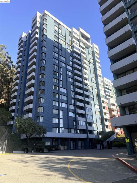 Multi-story building featuring numerous private balconies, a blue exterior facade, and multiple windows