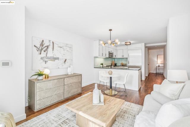 Living area featuring a chandelier and dark wood-style flooring