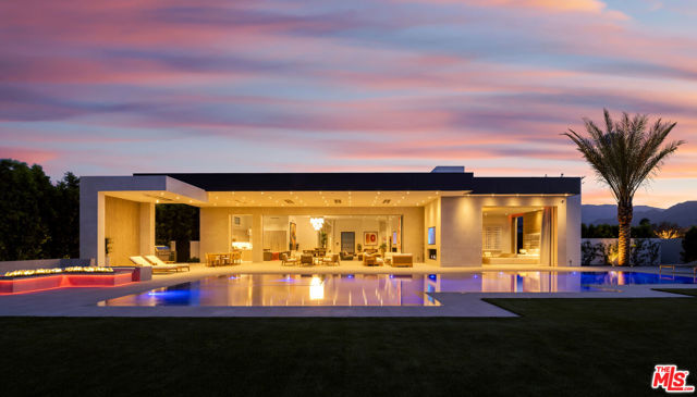 81370 Peary Place La Quinta, California Stunning new and private warm contemporary with explosive golf and mountain views on one of the best streets in the ultra desired Madison Club. Top of the line design and construction and that special world class interior design touch that makes instant magic happen and gives you goose bumps as you walk in and imagine the life style experience this property would surely provide it's future very lucky owner. The perfect open floor plan with more than 13,000 SF under roof and Approx. 9,400 SF under A/C boasting a total of 9 beds (6 bedroom suites) including an approx. 1,800 SF 2-bedroom guest penthouse with fireplaces and mountain views, a killer cinema, Italian main kitchen and chef kitchen, a bar area, 3 car garage and an additional golf cart garage all tiled and with RGB lighting, shaded car port and large and gated motor court, a zero edge oversized pool with a large built in fire pit area, covered patio and loggia with 4 different sitting areas, outdoor living room with a fireplace, extensive BBQ area, a private master patio with a spa, outdoor shower and a fire pit, and one of the nicest closets/bath combos out there. A massive sound system fills the spaces with warm and fuzzy bass and perfect frequencies and 16 TV's plus one 210" screen deliver perfect images of the many Apple TV's around. Top of the line home automation and control and the most efficient AC system available today modulating up to 26 SEER joining the solar system of the house in maximizing future savings. Sold furnished and including 19 abstract art pieces curated especially for the property. And yes full sun on the pool and full shade on the covered patio all day...every day...weekends and winter included.