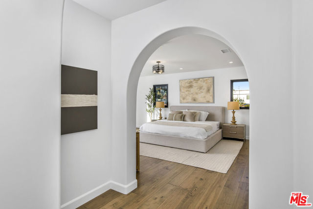 Spanish arches invite you to your primary bed sanctuary