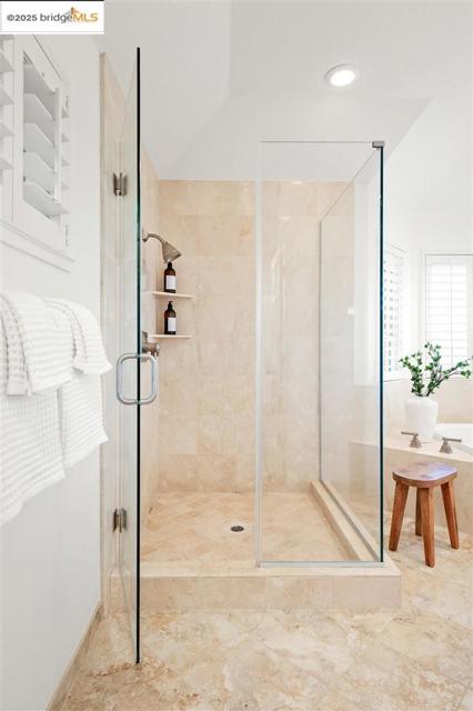 Bathroom with a stall shower and a bath