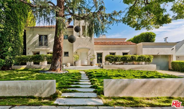 610 N MAPLE Drive Beverly Hills, California A very special property located on one of the most sought after streets in Beverly Hills. This custom contemporary estate was designed by world famous and acclaimed Cuban decorator Waldo Fernandez . His unique artistry is seen and felt throughout the house. While offering an incredible wow-factor the moment you step inside, there is also a sense of serenity. A lush green front yard invites guests into the beautiful home with a seamless transition from the outside to the spectacular interior incorporating culture and greenery with beautiful sculptures, pottery, and artwork. An open floor-plan layout is more than a just a feature, it's an artistic movement beginning with the Bell Tower entry chandelier designed by Alison Berger. Every step through the space highlights hardwoods, modern but warm finishes. The living room features a glowing fireplace with vaulted ceilings, the dining room with windows offers natural light . Be lifted away by this architectural moment.