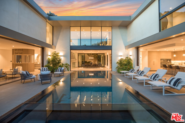 1860 N Doheny Drive Los Angeles, California Located on a cul-de-sac atop the famed Bird Streets in the Hollywood Hills, this contemporary estate offers seclusion paired with ease of access to the Sunset Strip, West Hollywood, and Beverly Hills. Newly constructed and never resided in, the home has 5 beds/8 baths across a total of 8,200 SF complete with skyline views across LA. Heightened ceilings & dramatic walls of glass open the main floor to the custom zero edge pool & exterior living areas, maximizing the indoor/outdoor lifestyle. The formal living & dining rooms, complete with a bespoke bar & glass wine vault, are ideal for entertaining while the kitchen opens into an airy family room. Upstairs, a gracious primary suite takes advantage of the homes views while 4 more ensuite bedrooms & a second living room round out the floor. Added features and details such as a media room, fitness room, surround sound system, built-in smart home technology, & intricate designer touches elevate the property to the highest luxury standard.