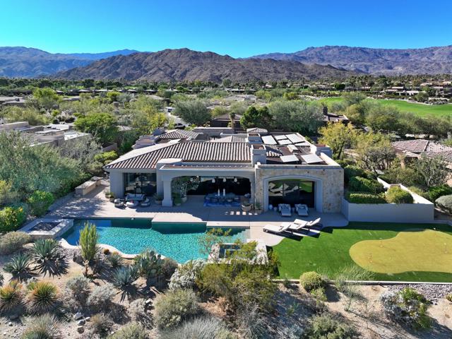 Stunning panoramic views to the golf course and mountains beyond are captured from this 5,031 square foot contemporary Villa located on the 5th fairway nestled within The Reserve. Beautifully updated living areas offer an open and modern design throughout. The gourmet kitchen is adjacent to the family room with easy access to the outdoor built in BBQ and nearby the gorgeous formal dining room overlooking the private courtyard. The expansive primary bedroom boasts a luxurious en-suite bathroom, while each additional bedroom offers comfort and style. In addition, the casita includes a living room with breakfast bar and large bedroom. Outside, indulge in resort-style living with a pool, spa, fire feature and putting green, ideal for relaxing and entertaining in the beautiful desert climate day or evening. Numerous custom features, including Solar, Control Four System in Primary Bedroom and Kitchen, Pentair Control for Pool and Spa, Water off System, Central Water Filtration and Motorized Shades throughout. Experience the best the desert lifestyle has to offer!