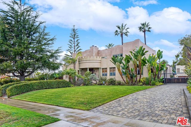 233 MARGUERITA Avenue Santa Monica, California Stately 1920s Spanish set on an extraordinary 22,400+ square foot lot! Premier West of 4th location, North of Montana Avenue. This lot is breathtaking! Impeccable landscaping & grassy lawns, a huge pool & spa, play-area, heated loggia, BBQ kitchen, detached guest house, beautiful brick parking pad & driveway. Renovated by architect Philip Vertoch. Filled with natural light, hardwood floors, generously sized rooms, Control4 tech, solar panels & 3-zone heating & AC. The main level includes a library, den & maid's room, PLUS a lovely, large bedroom with spa bath that opens to the backyard- a great feature if one needed a primary bedroom downstairs! Fantastic indoor/outdoor living via huge sliding doors leading from the family room to the enormous backyard. The lower level features a speakeasy-style media/game room complete with fireplace & charming bar. Upstairs, a family lounge & deck overlooking the gorgeous palm-filled backyard serves as a central area for three large bedrooms. This 2nd primary suite enjoys vaulted ceilings, fireplace, dual walk-in closets & luxurious bath with heated floors. The 3-garage is carpeted and could be used clubhouse space with pool bath . Above the garage is an excellent 1bd+1ba guest house, complete with kitchen area. One of the most impressive lots in Santa Monica!