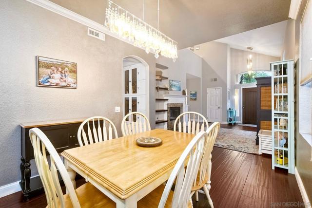 The Dining Room features a custom light fixture and opens into both the Kitchen and Living Room.