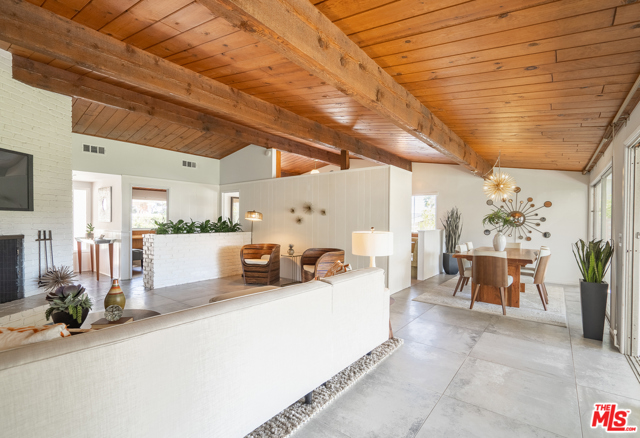 851 Enchanted Way Pacific Palisades, California It's here! The perfect mid-century home that has been meticulously cared for by the same family for decades. Updates in all the right places, yet opportunities to personalize and make this a show stopper. Upon entry, gorgeous vaulted ceilings, classic mid-century indoor planter, and views as far as the eyes can see capture your attention. The layout is a smart 3br/3ba WITH an office that could be a fourth bedroom, kitchen with booth, fabulous built-ins and large master suite. The home feels larger than it is with pitched, exposed wood beam ceilings throughout, large windows and sliding doors spilling out to the backyard. The unobstructed canyon view merging with the infinity grass yard brings the nature inside, and peak-a-boo ocean views from the kitchen sink window and backyard are beyond therapeutic! This house, and large lot, is special! Updates include recent installation of HVAC, new roof, appliances, flooring, shower doors, covered patio with lighting, and more!