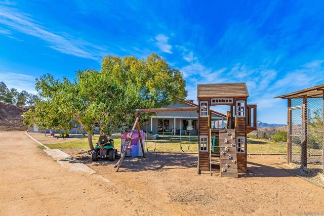 Backyard with chicken coop, ride-on lawn mower and play area - all convey