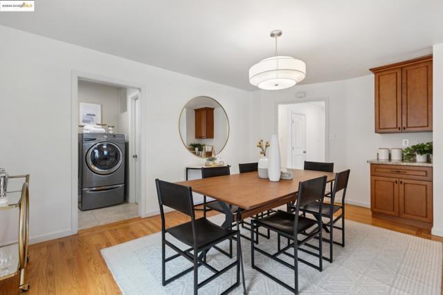 Dining space with light wood finished floors and washer / dryer