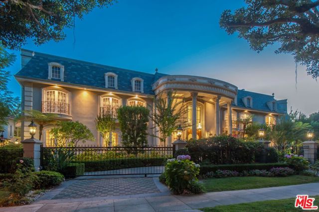1005 N Rexford Drive Beverly Hills, California We proudly present the iconic Rexford Edward Estate! A truly rare opportunity in prime Beverly Hills. Situated prominently on a desirable tree-lined street North of Sunset Boulevard, lies this gorgeous estate property featuring a grand eight-bedroom and twelve-bathroom home with expansive grounds, pool, and lighted tennis court. The elegant floor plan is ideal for a sophisticated but comfortable lifestyle. The dramatic foyer flows to the formal living room, large family room with exposed beam ceilings and warm stone fireplace, formal dining room, gourmet kitchen, and exquisite two-story wood paneled library with beautiful detailing. There are eight bedrooms including a secluded staff quarters and a luxurious private master wing. The master suite features dual bathrooms with walk-in closets, a separate sitting area or office, and a lovely private balcony. You will love entertaining in the sprawling upstairs media room with exposed beam ceilings and bar.