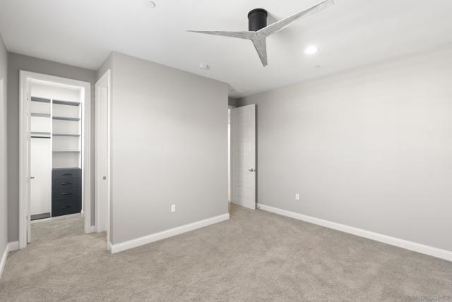 Ensuite bedroom with walk-in closet with closet organizer