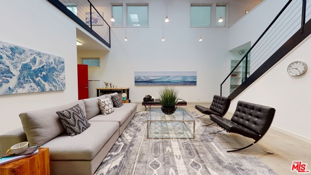 703 Milwood Avenue Venice, California Nestled in the celebrity community of Venice this elegant Architectural New York style loft masterpiece is perched on one of the best locations in Venice with incomparable workmanship and design. This beautiful open floor plan light-filled architectural home offers over 4600 sq/ft of living and entertainment space with 4 bedrms and 3 full baths with very high ceilings & great wall space for artwork. A two-story formal entry leads to a gorgeous living room with polished concrete floors. To the left, incredible four-car garage has 2x height ceilings, concrete flooring, custom storage & a roll-up gate. Three bedrms downstairs with one impressive en-suite master bedroom w/den. Another bedroom offers a recording studio within the bedroom and a third bedroom has an open floor space which includes a large office space. All bathrooms have an inviting walk-in shower, and the upper-level shower has room for a spa tub. Walk to the upper floor, to the left en-suite master bedroom with open walls & an enormous walk-in closet w/custom shelving. A Lovely roof-top deck to enjoy the sun during the day or wine gathering at night overlooking treetops. To the right of the stairs, Designer kitchen boasts Cesar stone counter-top with Berlin customized commercial range hood and High-End appliances. Upper level also features a very large living and dining rm.