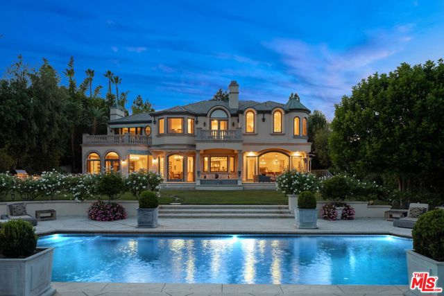 3352 Clerendon Road Beverly Hills, California Exclusive celebrity-owned home in the prestigious, 24-hour guard-gated Mulholland Estates. The French Chateau-style estate sits on over a 1/2 acre and epitomizes luxury. Featuring grand foyer w/ chandelier & spiral staircase, formal living room w/ herringbone wood floors, formal dining area overlooking the grounds, and timeless wood-paneled library. The chef's kitchen w/ custom marble backsplash & countertops, Viking appliances, alkaline water filtration system, and windows looking out over the elegant fountain. Family room w/marble fireplace, built-in shelves, wet bar & projection screen. Upstairs primary suite includes a step-down sitting area w/ two-way fireplace & balcony with the best views in Mulholland Estates. Impressive master bath features custom marble, a deep soaking tub, and spa-like sauna. Immaculate and private backyard includes a pool & spa, lounge area w/ fire table, and built-in bbq. A once-in-a-lifetime opportunity to own this entertainer's dream estate.