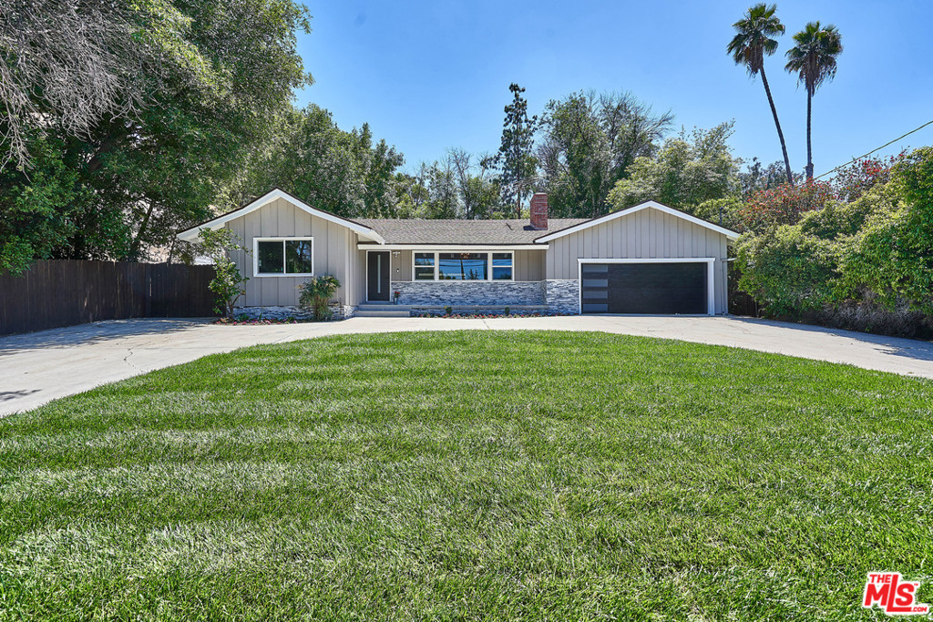 This exquisitely remodeled modern Ranch home sits on a 19000+ SQ FT lot behind your private gates . It is turnkey, unassuming, and embodies the finest living in the Woodland Hills near Westfield Topanga and Village, offering privacy and seclusion, beautiful finishes, and features too numerous to mention. The impeccable touch of a master craftsman can be seen throughout the home. Highlights include custom paint, sliding doors, luxurious flooring, recessed lighting, a fireplace, spa like bathrooms, lots of storage, and a beautiful kitchen outfitted with elegant counter tops, black stainless steel appliances with a built in computer in the refrigerator. A crowd favorite is the huge sliders that opens to the back yard to easily transfer food and drinks to guests enjoying the private, lushly landscaped backyard and large pool.