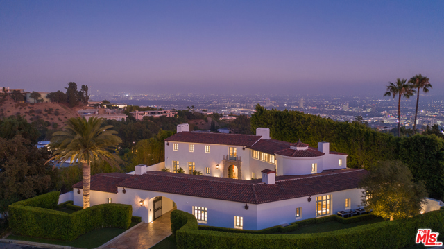 9240 Robin Drive Los Angeles, California Now listed at $10M below the initial market price! Newly built and never occupied, this uniquely realized world class estate is on a quiet cul-de-sac in one of Los Angeles' most coveted neighborhoods with neighboring homes selling upwards of $40 million. Designed by award-winning architect Richardson Robertson III, renowned for "Fleur de Lys" in Bel Air, the home boasts striking views from downtown to the ocean, with meticulously designed interiors and finished with the finest European materials. Features include four bedrooms, eight baths, 800-bottle wine cellar, theater, library and a "to be completed by the builder" entirely redesigned & enlarged rear yard and sparkling pool with skyline city views. The lavish master suite features fireplaces in the bedroom and sitting room capturing sparkling, top-of-the-world views. Unique to the area, a Porte cochere leads to lush, level gardens circling the grounds. A perfect combination of International luxury and glamorous Hollywood lifestyle.