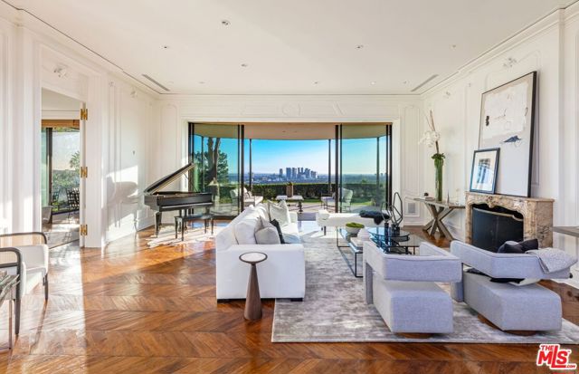 1010 N Hillcrest Road Beverly Hills, California This legendary estate, recently re-imagined, embodies Trousdale's unparalleled DNA w/superlative panoramic views & utmost privacy on lower Hillcrest, the most sought after street in Beverly Hills. The lot was originally handpicked by founder Paul Trousdale himself. Behind gates & up a magnificent tree-lined driveway is an extraordinary Hollywood Regency residence penned by John Woolf, famed architect sought by the greats like Errol Flynn, Judy Garland & Bob Hope. Its living room w/wall-to-wall sliders & alfresco dining area is perfectly situated to appreciate the jetliner views. Relish the sight of lush trees from its glass dining banquette & kitchen. The luxurious primary suite opens up to an aqueous oasis featuring a pool encircled by pristine boxwood landscaping & explosive city to ocean views. Includes posh upper-level guest suite, rare for Trousdale, that can't be replicated; detached guesthouse & 10-car motor court. Live among the world's elite in this iconic historical estate.