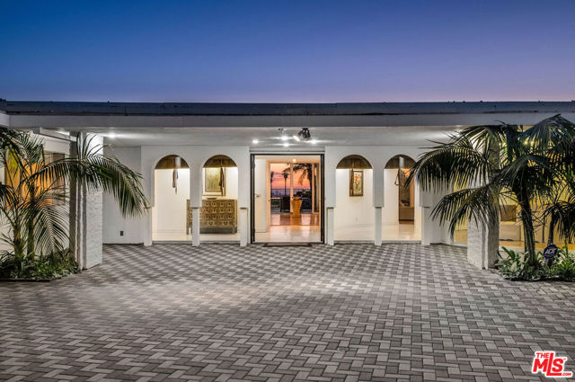 450 TROUSDALE Place Beverly Hills, California Nestled in one of the most coveted Beverly Hills locales, awaits this luxurious gated estate. Spanning over an acre on a coveted promontory, the property boasts jaw-dropping unobstructed views of the city & ocean. The estate spans an impressive 7,000SF of living & features a resort-like yard w/lush landscaping, pool, spa, BBQ & endless patio space for dining/lounging al fresco. Unwind in the spacious & sumptuous master suite with direct yard access, walk-in closets & spa-like bath. Amenities includes well-appointed guest suites, gracious open living space for a seamless flow, sliding glass doors for indoor/outdoor living, interior bar, library space w/fireplace, chef's kitchen, formal dining, & so much more. A private retreat, only moments from the most iconic Beverly Hills landmarks, this property is prepared to cater to all lifestyles. A true dream with endless potential, make this prestigious property yours today adding your own personal flair or develop into a new estate.