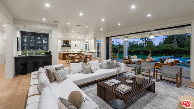 12730 Hanover Street Los Angeles, California Located in prestigious Brentwood Park, this beautiful brand new construction estate features the highest caliber of finishes, lush and spacious grounds and grand-scale living spaces that distinguish it among the neighborhoods finest homes. Beyond a secure and private motor court, doors open to a foyer, leading to a living room with a fireplace, study and formal dining room with butlers pantry to a phenomenal open chefs kitchen and great room with a bar, fireplace & sliding pocket doors to the grounds beyond. Upstairs holds a living area, 5 ensuite bedrooms with walk-in closets, including a gorgeous master bedroom with fireplace, exquisite dual showroom closets and spacious bathroom. An expansive lower level holds 2 ensuite bedrooms, a theatre, gym, wine room & entertainers dream bar. An incredible backyard features a pool, spa and sprawling lawn. An elevator, Savant system and 3-car auto gallery complete the offering.
