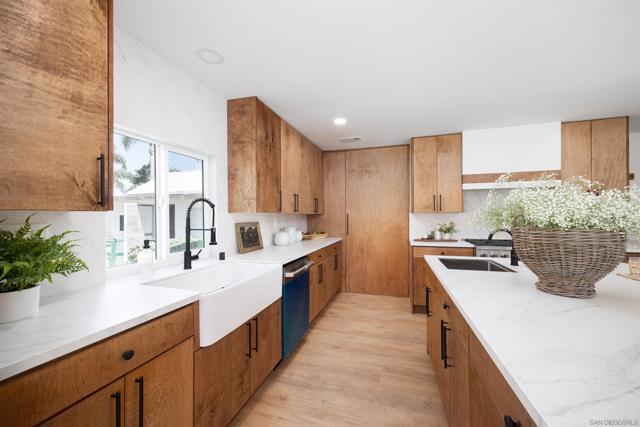 Custom hand built cabinets and porcelain backsplash along with upgraded appliances are the highlights of this kitchen