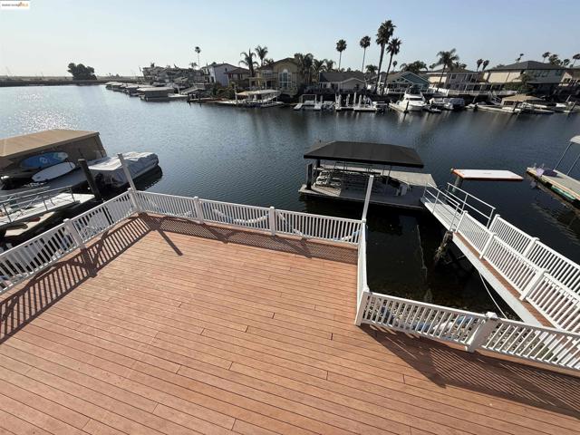 Dock area with a water view and a residential view