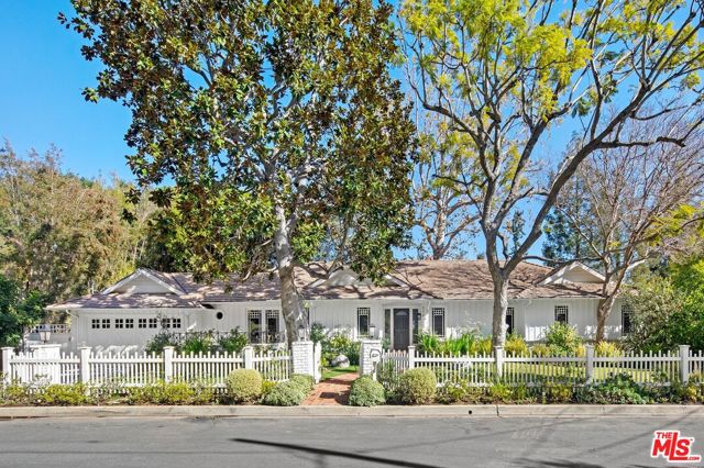 This elegant ranch property is located near the end of a quiet, tree-lined cul-de-sac in Rustic Canyon. Mature sycamore, oak and redwood trees surround the home, providing a beautiful and serene environment. The home is wonderfully accented by oversized windows looking out on a green vista of trees across the canyon. The primary suite and secondary bedroom along with the common areas are all located on one level, with additional living space below. There is a bright gourmet kitchen with top-of-the-line stainless steel appliances, center island, and a large breakfast area. The spacious primary suite has a fireplace, wall of windows, walk-in closet, and en suite bath. Amenities include a living room, formal dining room, den, spacious guest rooms, extra rooms for studio, gym or work space, with wood floors throughout.  Perfect for entertaining, the backyard has an inviting fire pit area, jacuzzi, and is surrounded by greenery providing maximum privacy. This coveted location between the Pacific Palisades Village and Santa Monica allows for quick and seamless access to the best of the Westside. A unique property in a picturesque setting, this is a rare offering!