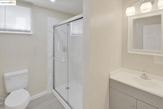 Full bath with vanity and a marble finish shower