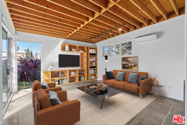 800 INDIANA Avenue Venice, California Gorgeous Unit in Architectural Duplex, built in 2004 by famed local Venice architect Peter Fergin is the perfect ratio of industrial chic and warmth. The design of the complex takes advantage of nature by incorporating large windows to bring in natural light, large patio spaces for enjoying the California weather and utilizes materials such as polished concrete flooring and wood ceiling paneling. In-unit laundry, radiant floor heating, Split AC systems, fireplace, a brand new fence and gate, LED lighting, private two-car tandem space garage and separate entryway both with direct access to unit and private outdoor space. Close to all of Venice, Santa Monica, and Silicon Beach