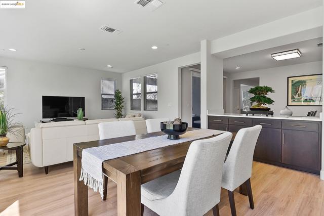Dining space with recessed lighting and light wood-type flooring