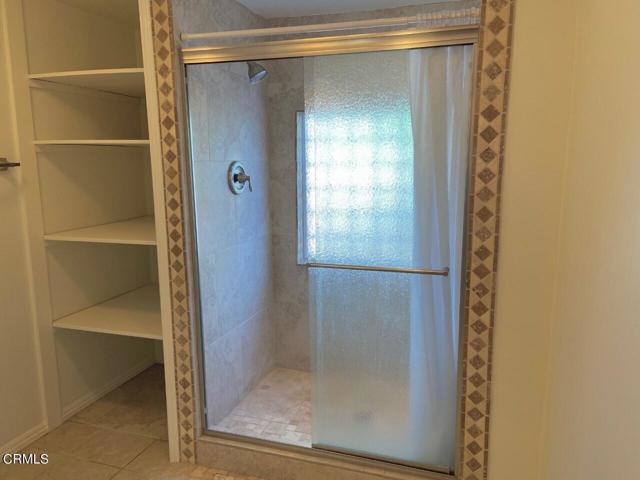 Tiled Shower & Linen Storage Area