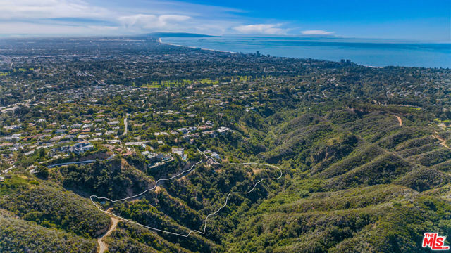 Nestled in Pacific Palisades' exclusive Riviera neighborhood, Casale Ranch offers a rare opportunity on a sprawling 6-plus acre estate behind secure gates. With breathtaking panoramic views of the ocean and canyons, this property promises unmatched privacy and tranquility. The grand entrance sets the tone, leading to the potential for an 18,340 sq ft main residence and a 7,240 sq ft guest quarters retreat. Imagine your dream home here, with space for a yoga studio, artists' sanctuary, or a lavish spa with a pool pavilion.This compound, one of the largest west of the San Diego Freeway, accommodates multi-generational living. Lush flora, hundreds of trees, and plants adorn the property. A flat landscaped area invites the creation of multiple pools, water features, sports/tennis courts, and outdoor entertaining spaces. Equestrian enthusiasts will find ample space for stables and riding trails. The gently sloping terrain and Mediterranean climate offer the possibility of cultivating a private vineyard and crafting a wine cellar with a tasting room.The Riviera neighborhood is renowned for its privacy, attracting A-list celebrities seeking seclusion without sacrificing city conveniences. Casale Ranch harmonizes the tranquility of a private oasis with the accessibility of an in-town address. It's minutes away from Palisades Village, Brentwood Country Mart, and Santa Monica Pier. This property epitomizes elevated perfection, where your every aspiration can come to life.