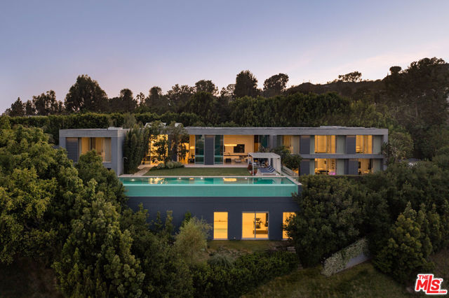 Meticulously designed with no expense spared, this architectural triumph by Marmol Radziner and Felicity Bell features over 14,000SF of artfully designed living space sited on over an acre on famed Perugia Way in prime Lower Bel-Air. Set behind gates at the end of a cul-de-sac, this estate greets you with its long driveway and motor court against the backdrop of breathtaking city, canyon, and fairway views of the Bel-Air Country Club. Built as a personal residence to an internationally renowned property developer and his discerning specifications, the home was constructed using only the finest quality materials, including exotic hardwood floors, trim, custom millwork, motorized Fleetwood glass doors, Italian kitchen, and imported fixtures and finishes. The formal living spaces boast a jaw-dropping 24ft+ ceiling height and an abundance of natural light - perfect for the world's most discerning art collector. Each bedroom suite is expansive and well-appointed, featuring walls of glass and spa-like bathrooms. Additional luxury living spaces include an indoor pool and gym, art studio, His/Hers closets, and a unique 2 bed, 2 bath guest, or staff quarters. Outdoor entertaining areas include various grassy lawns, a serene infinity-edge pool, and a cabana/sunbathing deck. Uniquely thoughtful in both design and finishes, this offering is a rare opportunity to own a magnificent estate with a European sensibility and quality that is a rarity in Los Angeles.