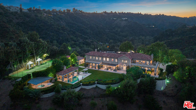 A spectacular 4.3 acre Bel Air estate in the ultra exclusive, Levico Estates, a 24 hour guard gated community. One of the most extraordinary values in a very long time. Enter via a 700 ft long private driveway to this incredible ivy-covered villa built with the highest quality of craftsmanship and interiors designed by the internationally renowned designer, Michael Smith. Featuring over 12,000 sf with every conceivable amenity. There's a stunning 2 story entry, large living room, library/office, gourmet kitchen with family room, gorgeous primary suite with dual baths and closets, gym, wine cellar, outdoor loggia, pool house, championship tennis court, large lawns, gardens, and spectacular grounds all overlooking drop-dead 360-degree city and canyon views. Just 3 minutes from the Bel Air Hotel surrounded by major estates. Truly a once in a lifetime opportunity to acquire a trophy property.