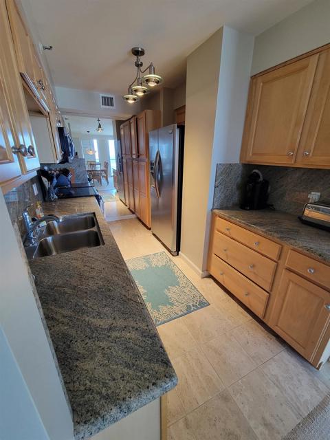 Stone counters, upgraded cabinets and stainless appliances enhance the fully equipped kitchen.