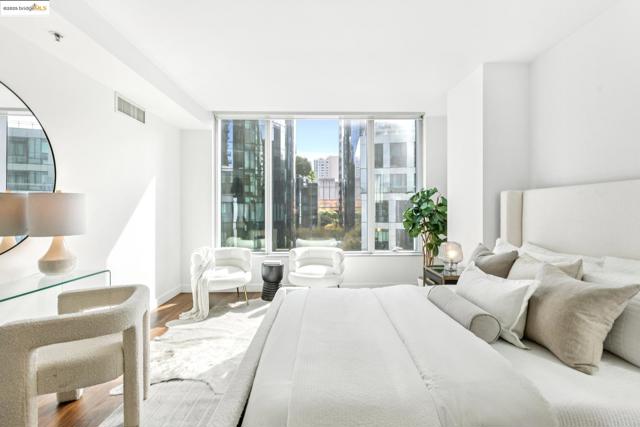 Bedroom featuring wood finished floors and a view of city