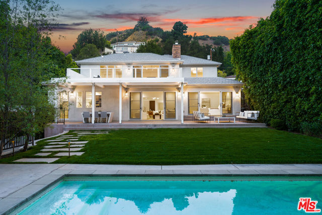 Located in the prestigious Beverly Hills Post Office on a quiet cul-de-sac right off Coldwater Canyon Drive stands this meticulous private and gated Traditional home upgraded with highest of quality modern touches. This 4,861 SF home features 6 bedrooms and 6.5 baths with a seamless indoor/ outdoor floor-plan. With designer finishes at every turn, you will find oak flooring throughout, designer light fixtures, and custom European cabinetry and hardware. Step into an oversized formal living room with marble fireplace that connect to both the dining room and family room which leads out to the backyard. The large chef's kitchen is fitted with Smeg & Viking appliances, marble countertops, center island, and large wine fridge. Upstairs you will find the grand master suite with fireplace, his and hers closets, and a massive terrace perfect for enjoying the canyon views. The spa like master bath contains dual vanities, large soaking tub, and glass enclosed steam shower. Downstairs features a generous junior suite with doors that lead out to the outdoor patio and backyard. The backyard is an entertainer's dream featuring a covered patio, large grassy area, and a sparkling pool and jacuzzi. The detached guest house is perfect for an entertainment room, large at home office, or for extended family to stay in. Don't miss your opportunity to live just 5 minutes away from the Beverly Hills Hotel, Coldwater Canyon Park and Downtown Beverly Hills.