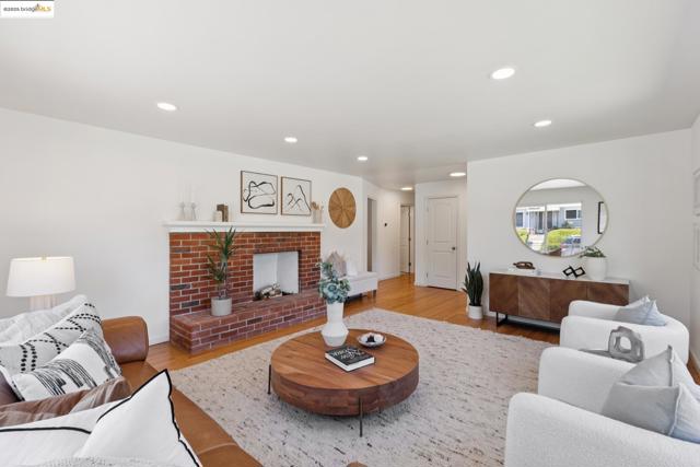 Living area with recessed lighting, a fireplace, and wood finished floors