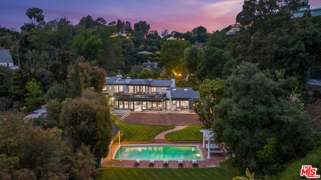 10981 Bellagio Road Los Angeles, California Situated in prestigious Lower Bel Air, this exclusive gated compound merges seamlessly with the fifteenth fairway of the renowned Bel Air Country Club, creating an endless expanse of lush mature landscaping culminating in a pastoral lake surrounded by towering trees. Recently renovated and ready for immediate occupancy, the main residence spans 6,200 square feet and showcases the epitome of indoor/outdoor living in Southern California. With a contemporary open floor plan designed for entertaining, this home, surrounded by estates valued at $50 million or more, presents an exceptional opportunity at an unbeatable price in a world-class location. Boasting four bedrooms and six and a half bathrooms, the main house includes a sophisticated primary suite with dual bathrooms and a sunlit office space. The spacious chef's kitchen features high-end Viking and Bosch appliances, a breakfast room, a wine refrigerator, an indoor brick barbecue, and captivating views of the impeccably manicured grounds.Additional highlights of this elegant compound include a separate pool house/gym with bathroom, a cozy library/reading room, and a generous upstairs deck overlooking an oversized pool. There is also a pool pavilion with a fireplace, multiple shaded patios for dining or relaxing, and an expansive lawn. The nearly one-acre lot offers a serene and park-like setting with extensive frontage, exceptional depth, and stunning views of the manicured fairways and greens of the golf course. While the residence is move-in ready, it also presents an opportunity for reimagining or redevelopment, potentially transforming it into a magnificent 15,000 sq.ft. estate. This remarkable property offers outstanding investment value and a rare chance to reside in or create a majestic golf course estate in one of California's most prestigious locations.