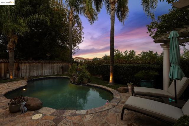 View of pool with a fenced backyard and a patio