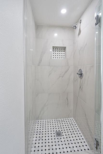 Beautiful custom shower with custom tile + cut out for bath/beauty products!