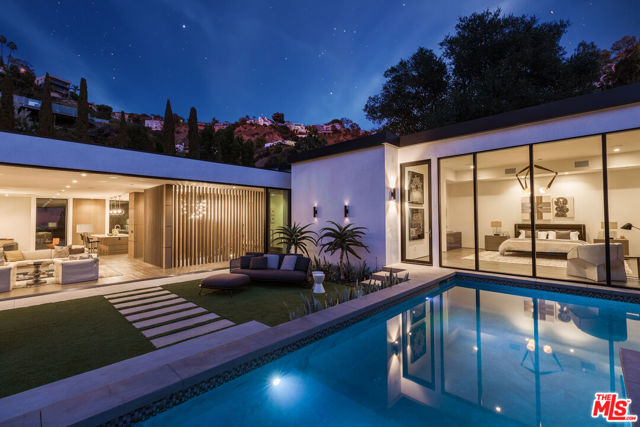 1717 Rising Glen Road Los Angeles, California New Price! Gorgeous sleek Modern home on a privately gated elevated lot above desirable Rising Glen Rd. in the famed Sunset Strip. Dazzling city light views. Great scale throughout with beautiful hardwood floors and walls of retractable glass. Open floor plan perfect for large-scale entertaining. Stunning kitchen with substantial center island that opens to large dining area. Living room has high ceilings and striking fireplace. Sumptuous primary suite with magnificent bath and walk-in closet. There is a second bedroom suite and powder room on the main level. An architectural focal point of the home is a dramatic staircase that leads you to a media room, bar, office and 3rd bedroom suite. Resort-like yard with sparkling pool, spa and expansive city views. 2-car garage with an additional space to park. A Contemporary triumph!