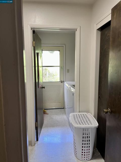 Downstairs laundry with door to rear yard