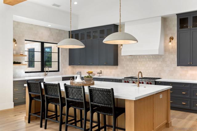 Beautiful, designer lighting over generous pull up island.