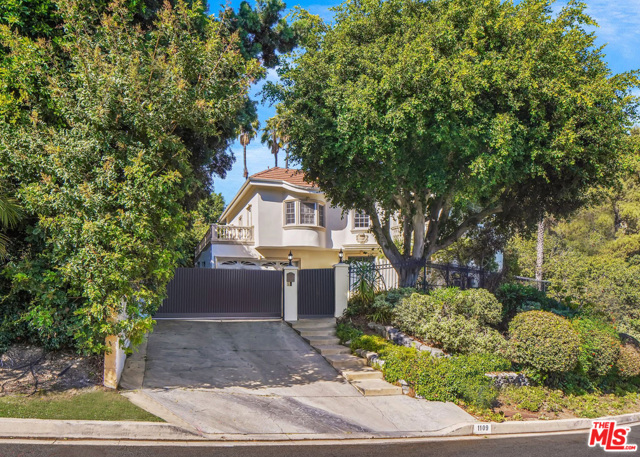 1109 Pine Drive Beverly Hills, California Nestled near the Beverly Hills Hotel, this ultra-private and expansive Mediterranean style home is situated behind tall hedges and features a welcoming 2-story formal entry, as well as a large private backyard with pool. Positioned above street level on nearly 14,000 square feet of flat land, the home features three large bedrooms with ensuite bathrooms upstairs and one downstairs. The kitchen has been elegantly updated and receives an abundance of natural light from the double doors that connect it to the backyard. Fully gated, the property is secure and secluded with space for entertaining or quarantining. Add a touch of personal taste to this unique home's character.