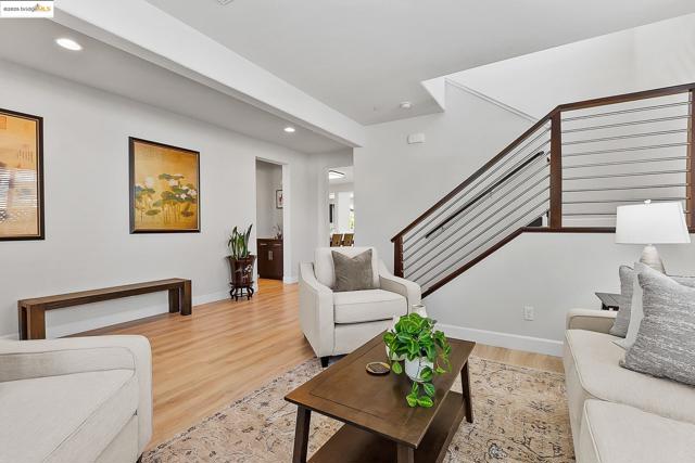 Living area with light wood-type flooring and recessed lighting