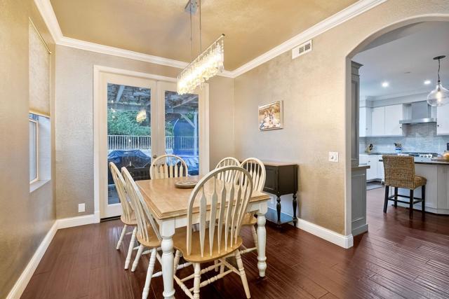 Featuring french doors out to the patio, the dining room  has easy access to the kitchen buffet.